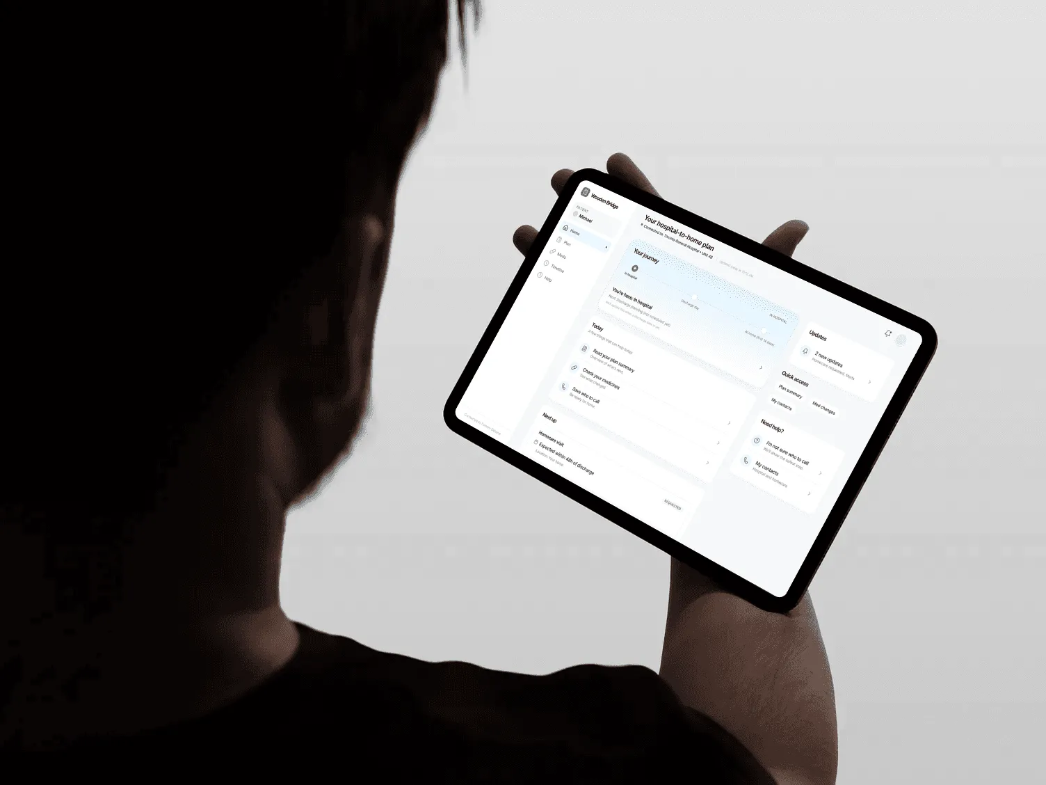 Wooden Bridge care plan shown on a tablet held by a person.